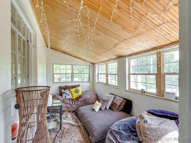 sitting room with wood ceiling, plenty of natural light, cooling unit, and vaulted ceiling