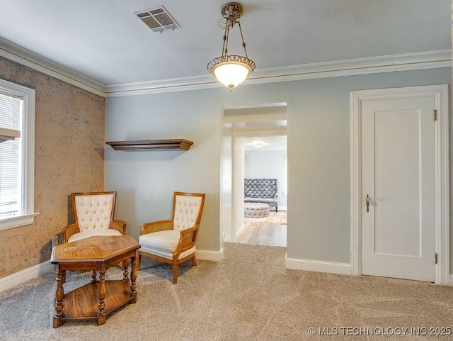 living area featuring carpet floors, crown molding, and baseboards