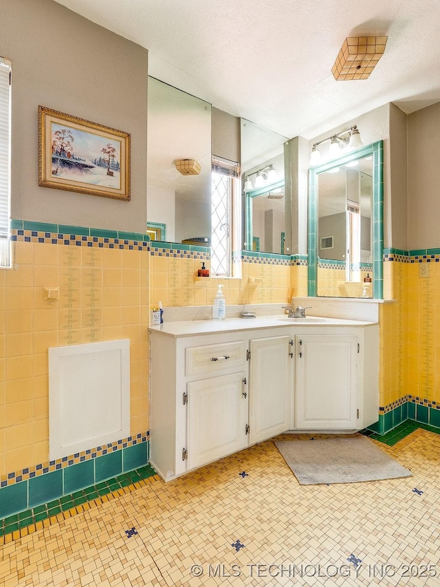 bathroom featuring tile walls and vanity