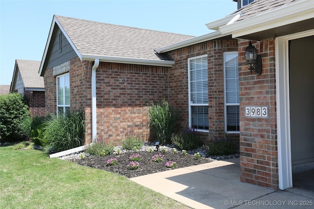 3983 S 216th E Ave, Broken Arrow, OK 74014 - view of exterior entry featuring brick siding, roof with shingles, and a yard