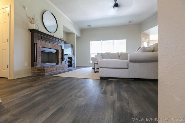 3983 S 216th E Ave, Broken Arrow, OK 74014 - living room with ornamental molding, a brick fireplace, wood finished floors, and baseboards