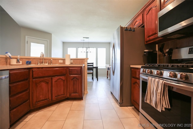 3983 S 216th E Ave, Broken Arrow, OK 74014 - kitchen featuring appliances with stainless steel finishes, a sink, pendant lighting, light tile patterned floors, and light countertops