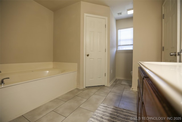 3983 S 216th E Ave, Broken Arrow, OK 74014 - bathroom featuring a garden tub, vanity, tile patterned floors, toilet, and baseboards