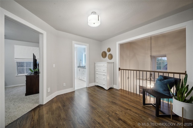 spare room with wood finished floors, baseboards, and a chandelier
