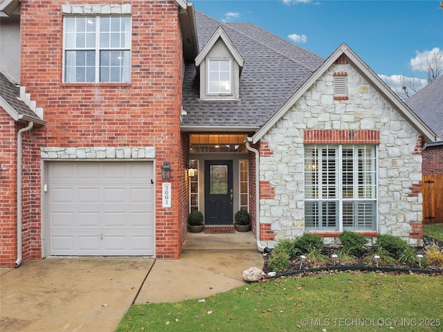 view of front of home with roof with shingles, stone siding, brick siding, and driveway