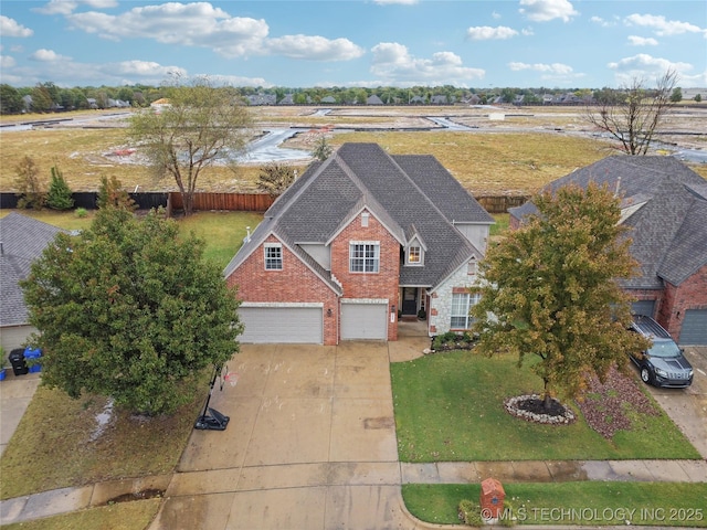 view of front of home featuring brick siding, driveway, and an attached garage