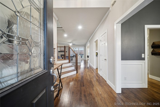 entrance foyer featuring wood finished floors, stairway, ornamental molding, baseboards, and ceiling fan