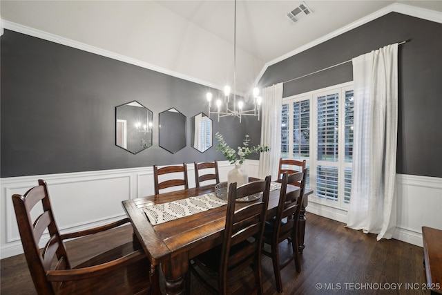 dining area featuring vaulted ceiling, a chandelier, dark wood-type flooring, a wainscoted wall, and ornamental molding