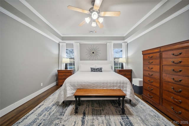 bedroom with wood finished floors, multiple windows, baseboards, and a ceiling fan