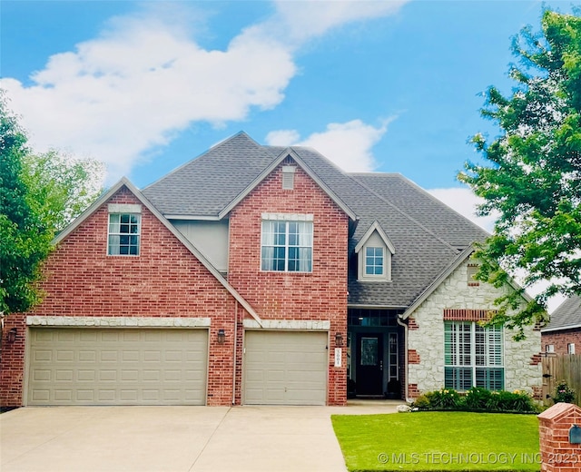 traditional home with concrete driveway, roof with shingles, a garage, a front yard, and brick siding
