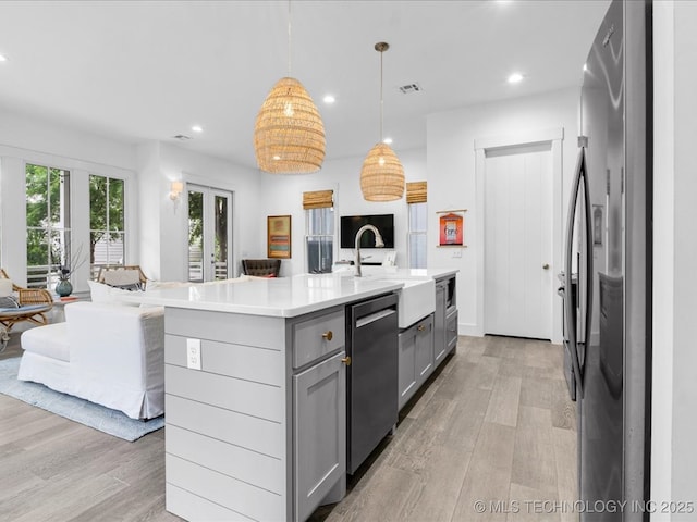 40 Center Ln N, Carlton Landing, OK 74432 - kitchen featuring gray cabinetry, stainless steel appliances, open floor plan, light wood finished floors, and recessed lighting