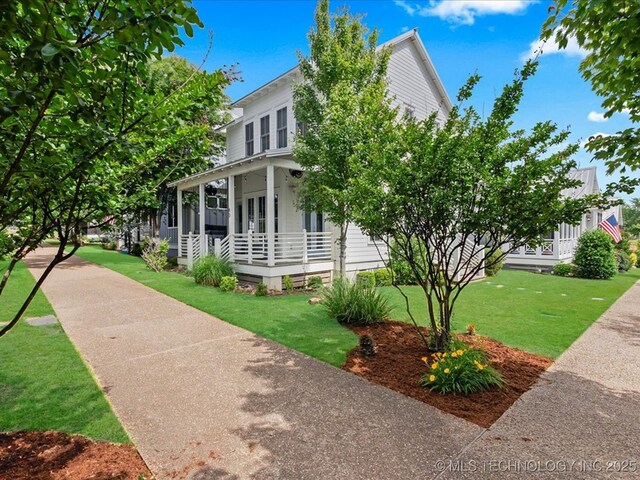 40 Center Ln N, Carlton Landing, OK 74432 - view of home's exterior featuring a porch and a yard