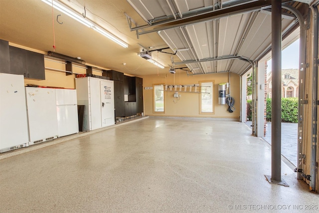 3107 E 88th St, Tulsa, OK 74137 - garage with a central vacuum unit, a garage door opener, and freestanding refrigerator