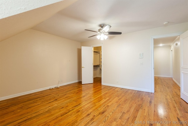 3107 E 88th St, Tulsa, OK 74137 - unfurnished bedroom with light wood-type flooring, a walk in closet, ceiling fan, and baseboards