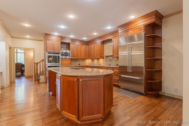 3107 E 88th St, Tulsa, OK 74137 - kitchen with built in appliances, open shelves, a sink, dark wood finished floors, and ornamental molding