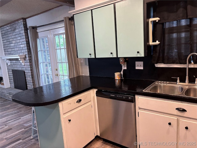 316 Barclay, Muskogee, OK 74403 - kitchen featuring dishwasher, a peninsula, wood finished floors, a sink, and dark countertops