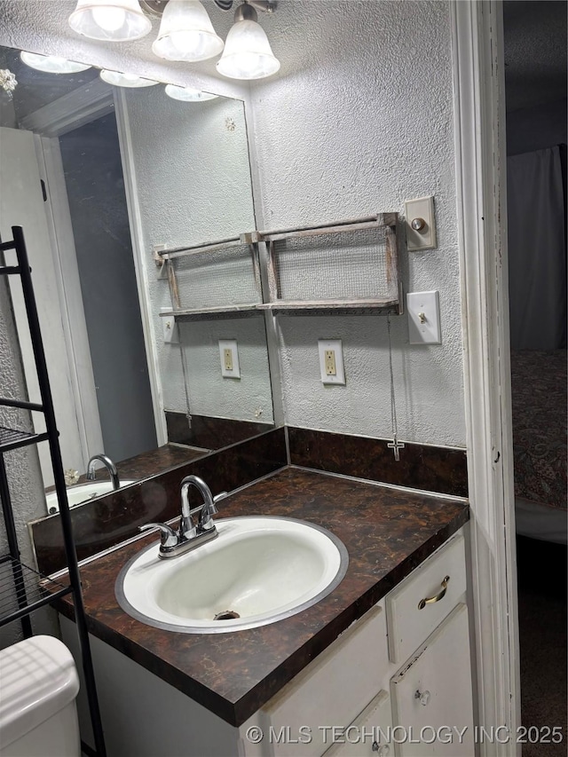 316 Barclay, Muskogee, OK 74403 - bathroom featuring vanity, a textured wall, and toilet
