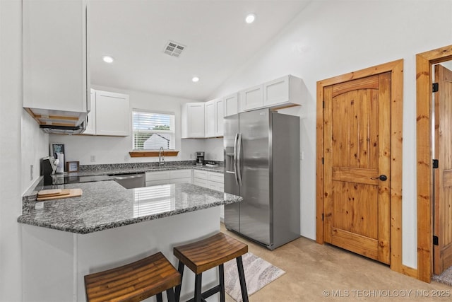 11879 Sandy Acres Trl, Kingston, OK 73439 - kitchen with appliances with stainless steel finishes, a peninsula, dark stone countertops, white cabinetry, and a sink