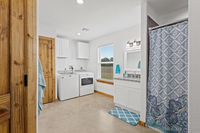11879 Sandy Acres Trl, Kingston, OK 73439 - kitchen featuring washing machine and clothes dryer, white cabinets, concrete flooring, a sink, and recessed lighting