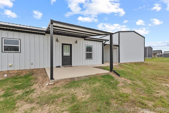 11879 Sandy Acres Trl, Kingston, OK 73439 - rear view of house featuring a patio area, a lawn, and metal roof