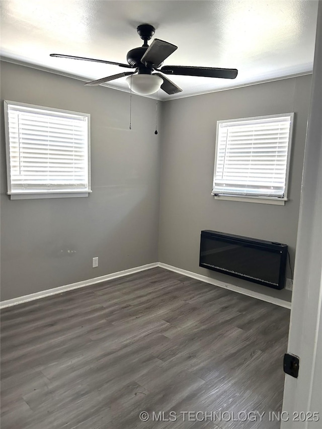 909 W Arkansas St, Durant, OK 74701 - spare room with a ceiling fan, wood finished floors, and baseboards