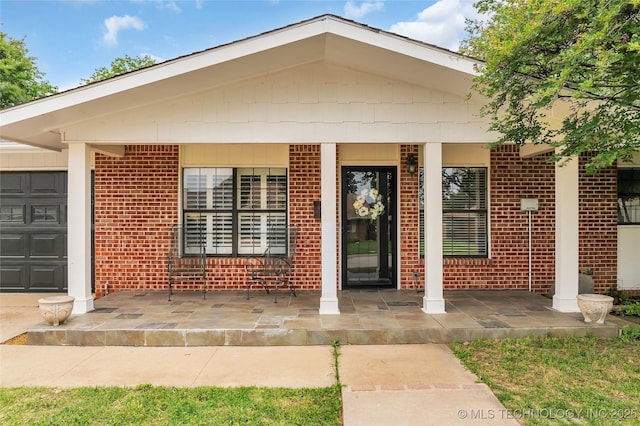 1919 NW 10th St, Ardmore, OK 73401 - doorway to property featuring brick siding and a porch