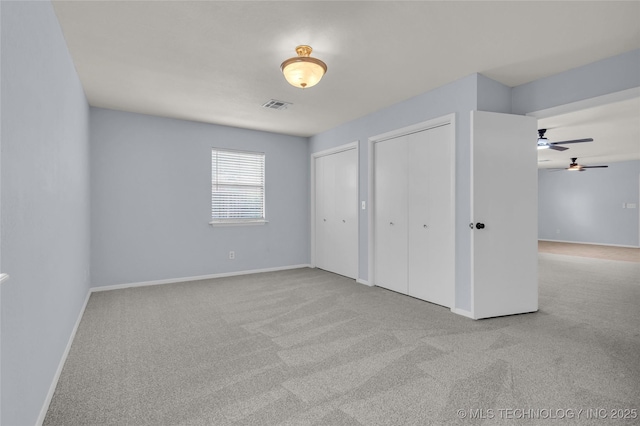 1919 NW 10th St, Ardmore, OK 73401 - unfurnished bedroom with two closets, carpet floors, and baseboards