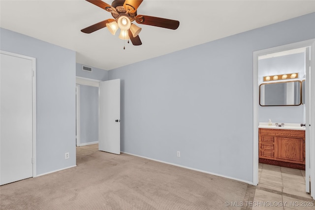 1919 NW 10th St, Ardmore, OK 73401 - unfurnished bedroom with baseboards, ensuite bath, light colored carpet, and ceiling fan