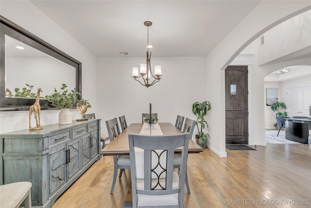 5412 E 122nd St S, Bixby, OK 74008 - dining area with arched walkways, light wood-style flooring, a chandelier, baseboards, and recessed lighting