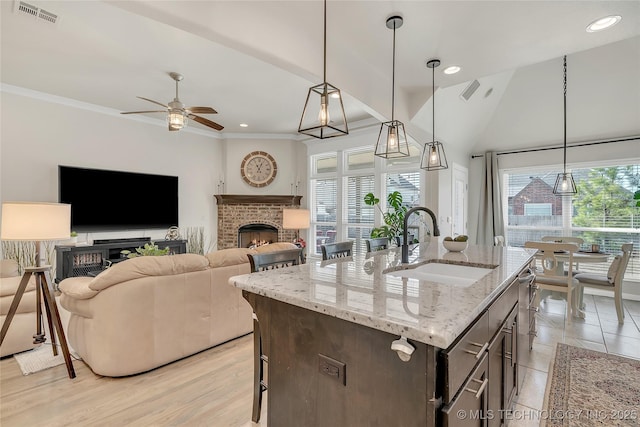 5412 E 122nd St S, Bixby, OK 74008 - kitchen with plenty of natural light, a sink, ceiling fan, a brick fireplace, and ornamental molding