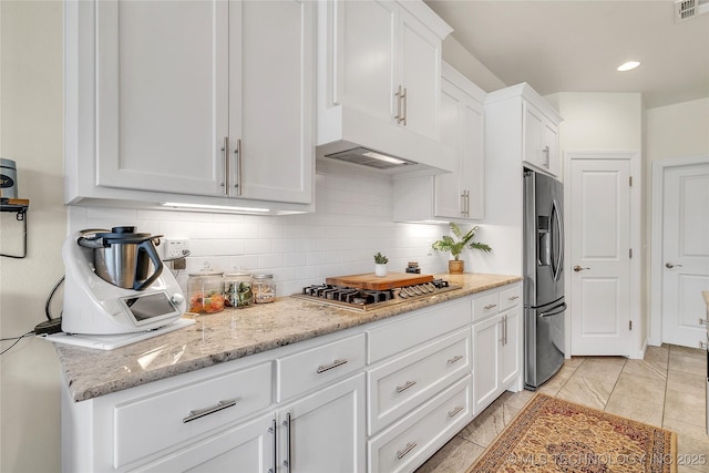 5412 E 122nd St S, Bixby, OK 74008 - kitchen featuring stainless steel appliances, white cabinetry, tasteful backsplash, under cabinet range hood, and light stone countertops