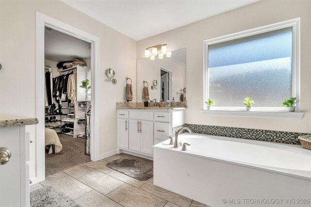 5412 E 122nd St S, Bixby, OK 74008 - full bath featuring vanity, a spacious closet, and a garden tub