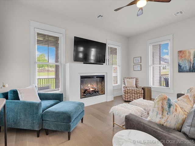 42 Redbud St, Carlton Landing, OK 74432 - living room with ceiling fan, healthy amount of natural light, and a warm lit fireplace
