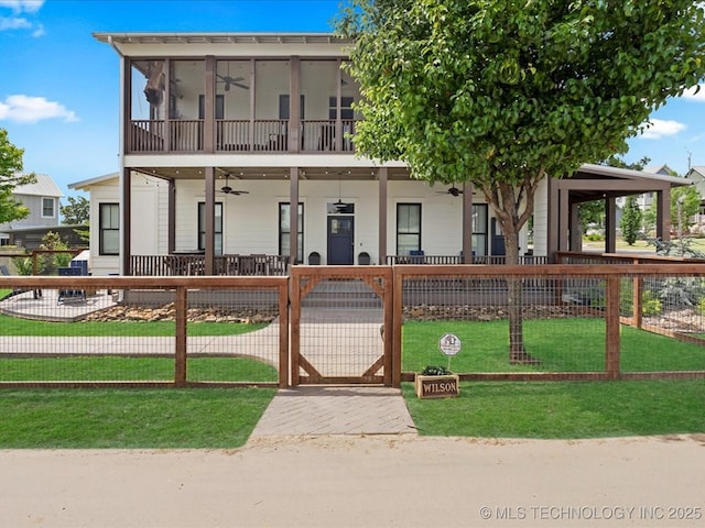 42 Redbud St, Carlton Landing, OK 74432 - view of front of home featuring ceiling fan, a gate, covered porch, and a sunroom