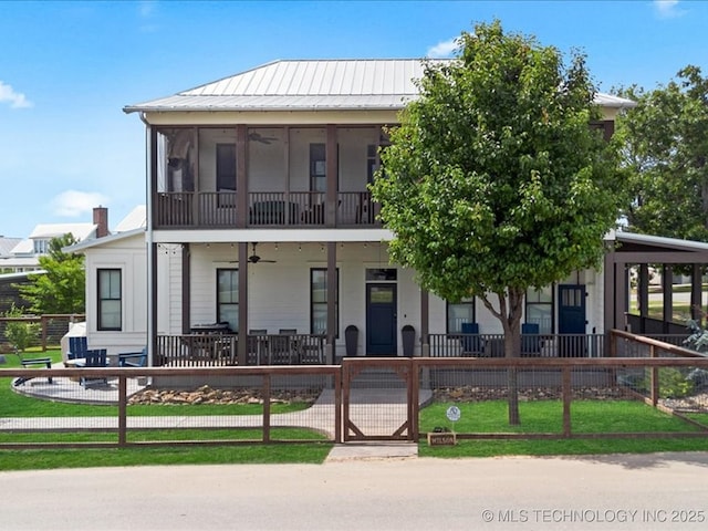 42 Redbud St, Carlton Landing, OK 74432 - view of front facade with a fenced front yard, a ceiling fan, covered porch, metal roof, and a gate