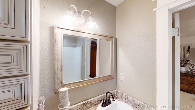 196 High Chaparal St, Ardmore, OK 73401 - bathroom featuring a sink and a textured wall