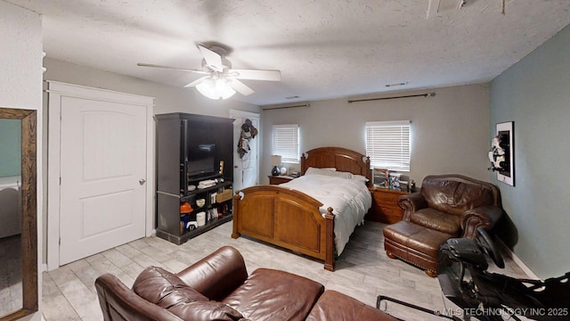 196 High Chaparal St, Ardmore, OK 73401 - bedroom with light wood finished floors, a ceiling fan, and a textured ceiling