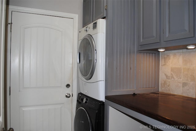 2025 E 134th St S, Bixby, OK 74008 - clothes washing area with cabinet space and stacked washer / drying machine