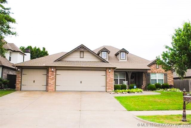 2025 E 134th St S, Bixby, OK 74008 - view of front facade featuring brick siding, a front yard, driveway, and a garage