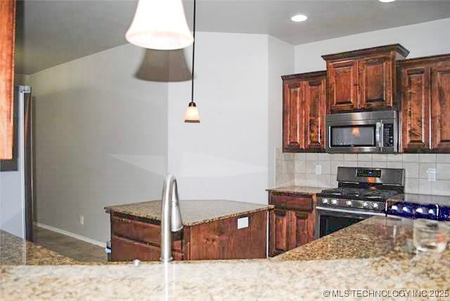 2025 E 134th St S, Bixby, OK 74008 - kitchen featuring appliances with stainless steel finishes, stone countertops, decorative backsplash, recessed lighting, and hanging light fixtures