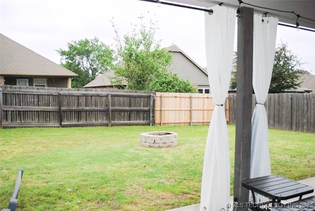 2025 E 134th St S, Bixby, OK 74008 - fenced backyard with a fire pit