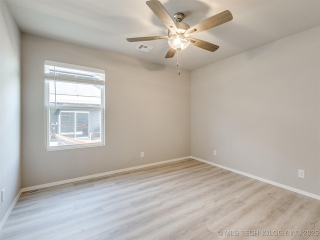 13402 E 124th St, Collinsville, OK 74021 - empty room with light wood-type flooring, ceiling fan, and baseboards