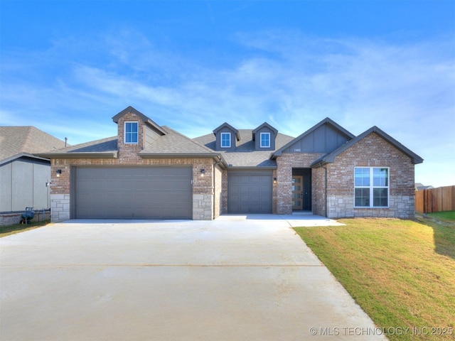 13402 E 124th St, Collinsville, OK 74021 - view of front of house featuring driveway, a garage, board and batten siding, brick siding, and a shingled roof