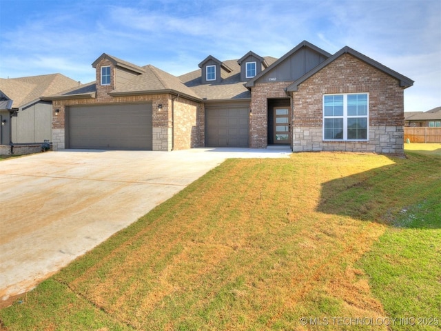 13402 E 124th St, Collinsville, OK 74021 - view of front of house with an attached garage, a front yard, driveway, brick siding, and board and batten siding