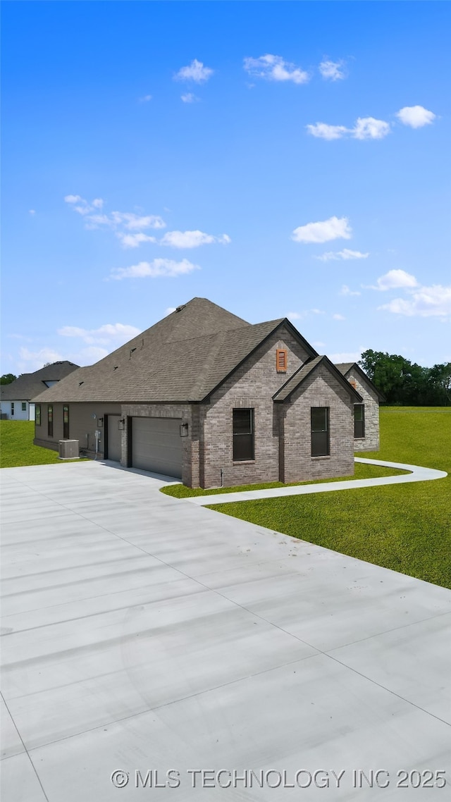 16321 E 101st St, Owasso, OK 74055 - view of front facade with a garage, a front yard, driveway, brick siding, and cooling unit