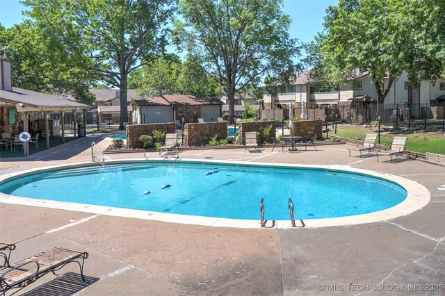 7911 E 66th St Unit 45H, Tulsa, OK 74133 - community pool featuring a patio area and a residential view