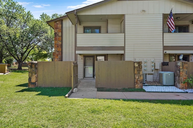 7911 E 66th St Unit 45H, Tulsa, OK 74133 - view of front facade featuring central AC and stone siding