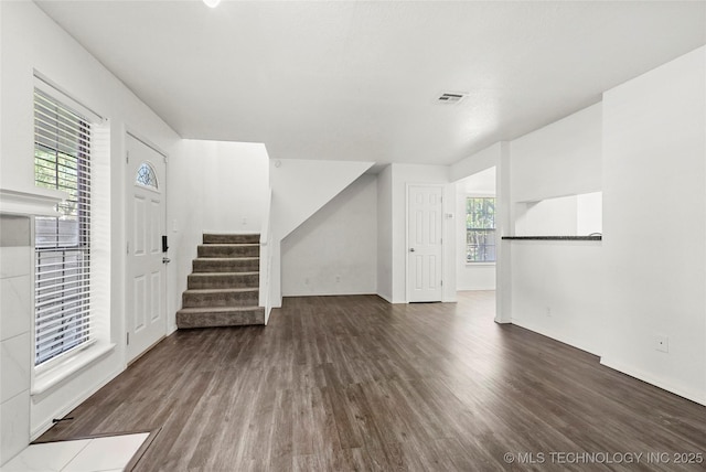7911 E 66th St Unit 45H, Tulsa, OK 74133 - unfurnished living room featuring wood finished floors, stairs, and baseboards