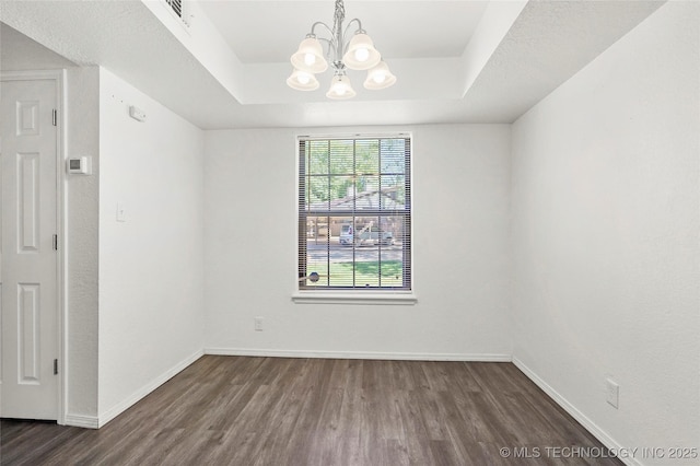 7911 E 66th St Unit 45H, Tulsa, OK 74133 - unfurnished room featuring wood finished floors, a chandelier, a raised ceiling, and baseboards