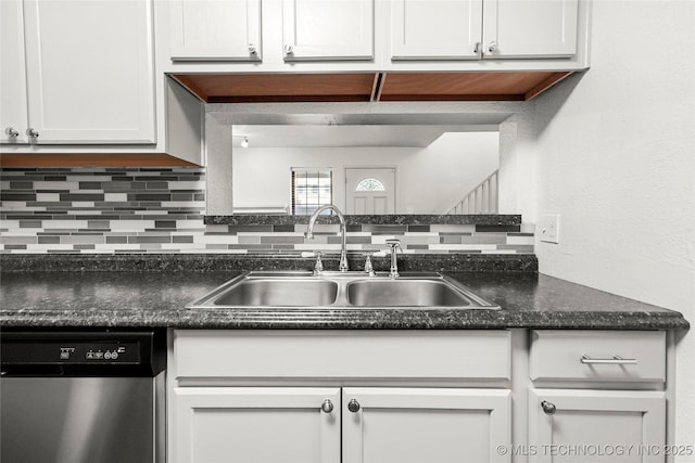 7911 E 66th St Unit 45H, Tulsa, OK 74133 - kitchen featuring dishwasher, a sink, tasteful backsplash, and dark countertops